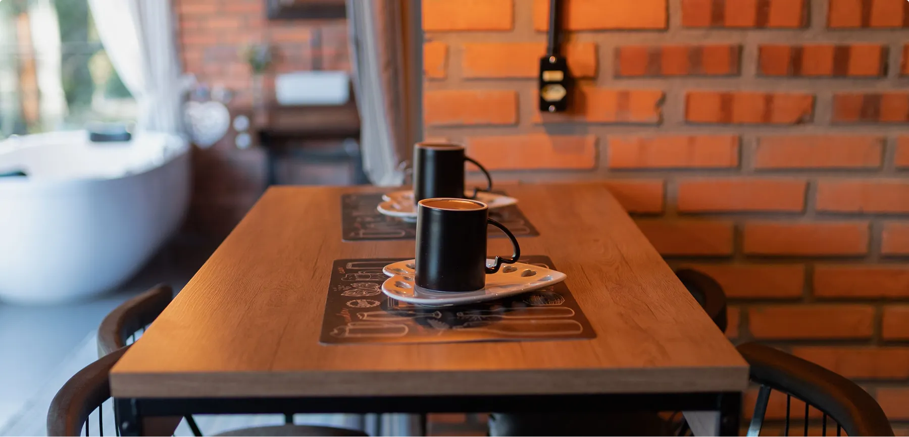A warm dining table with coffee mugs, representing life away from financial decisions
